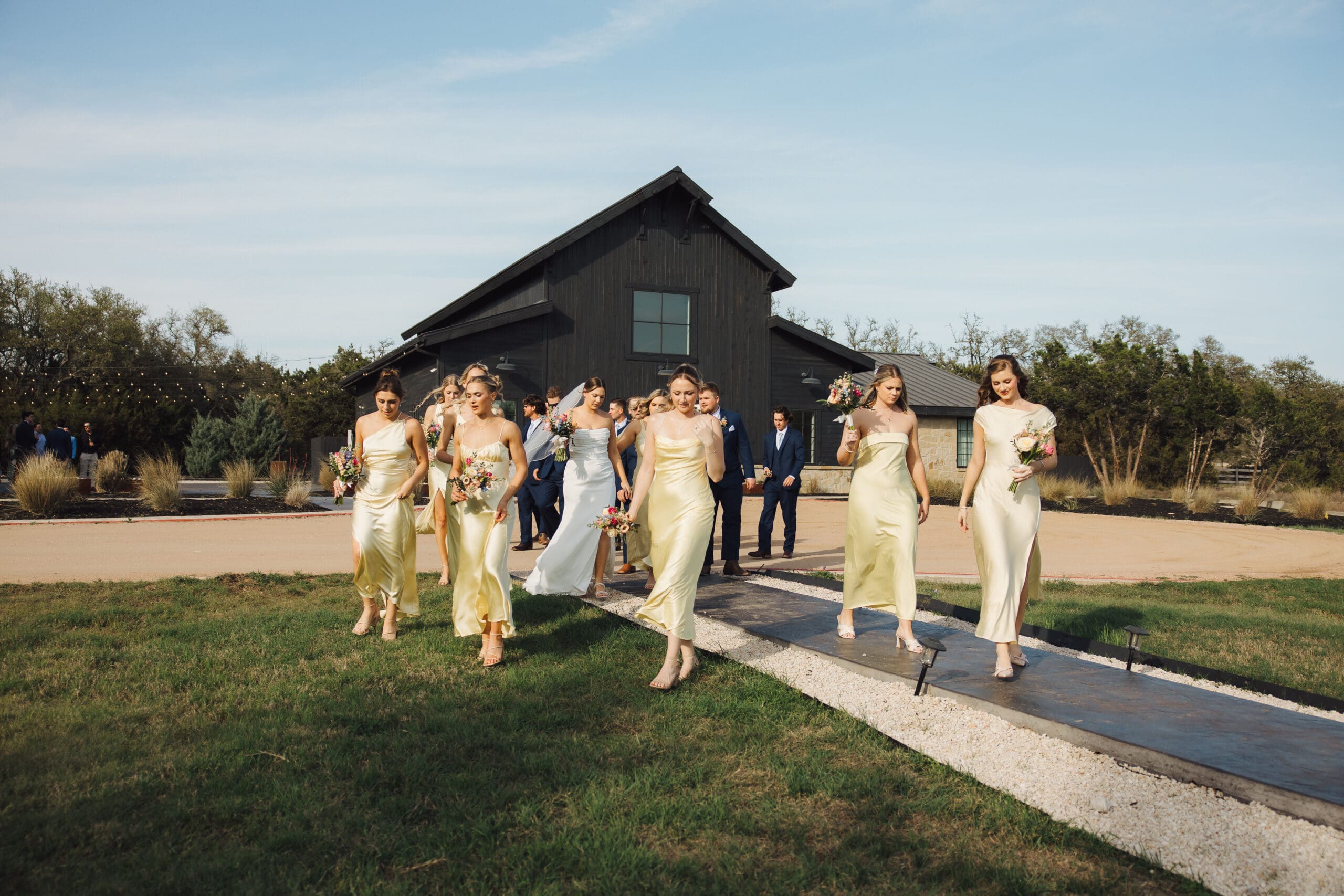 wedding party walking across grass at Morgan Creek Barn wedding