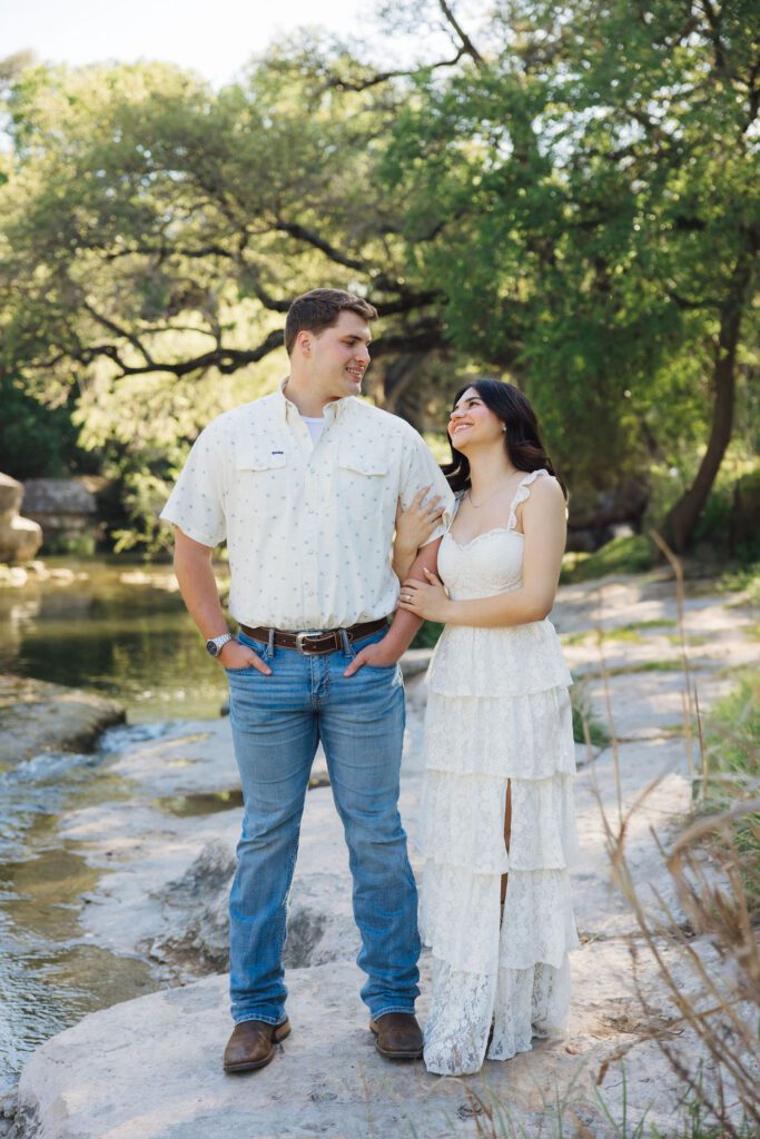 couple posing for engagement photos at Bull Creek District Park in Austin TX