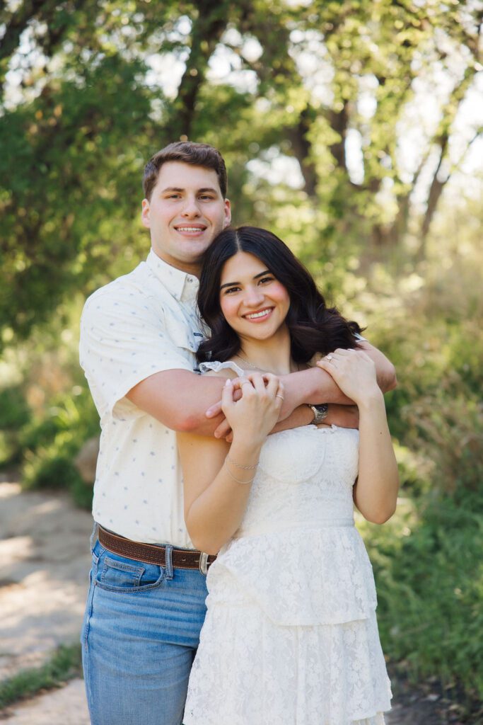 couple posing for engagement photos at Bull Creek District Park in Austin TX