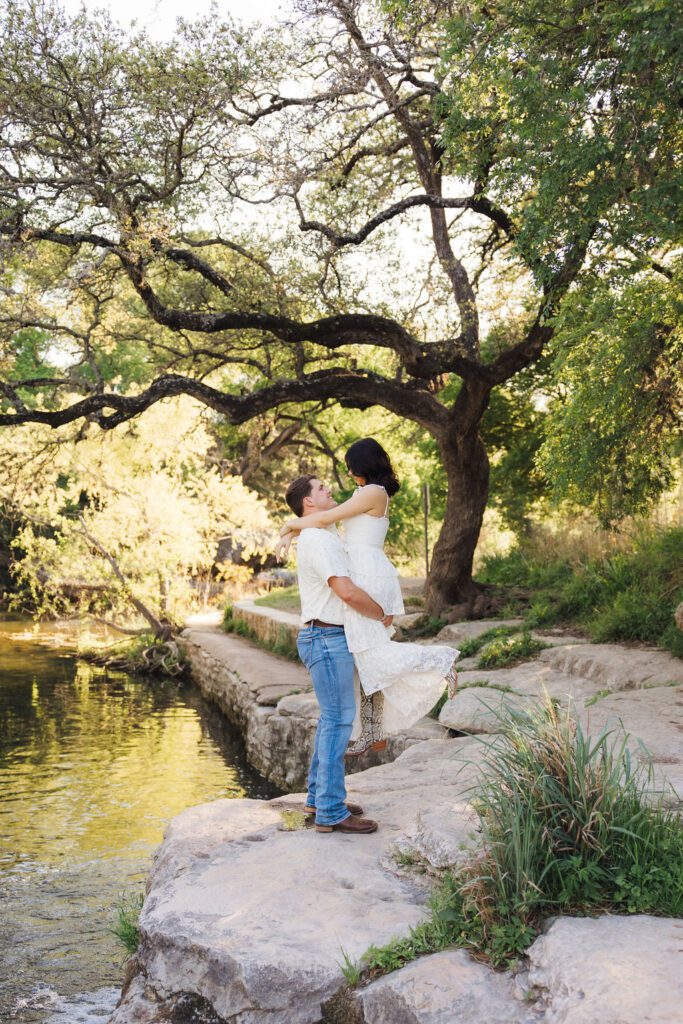 couple posing for engagement photos at Bull Creek District Park in Austin TX