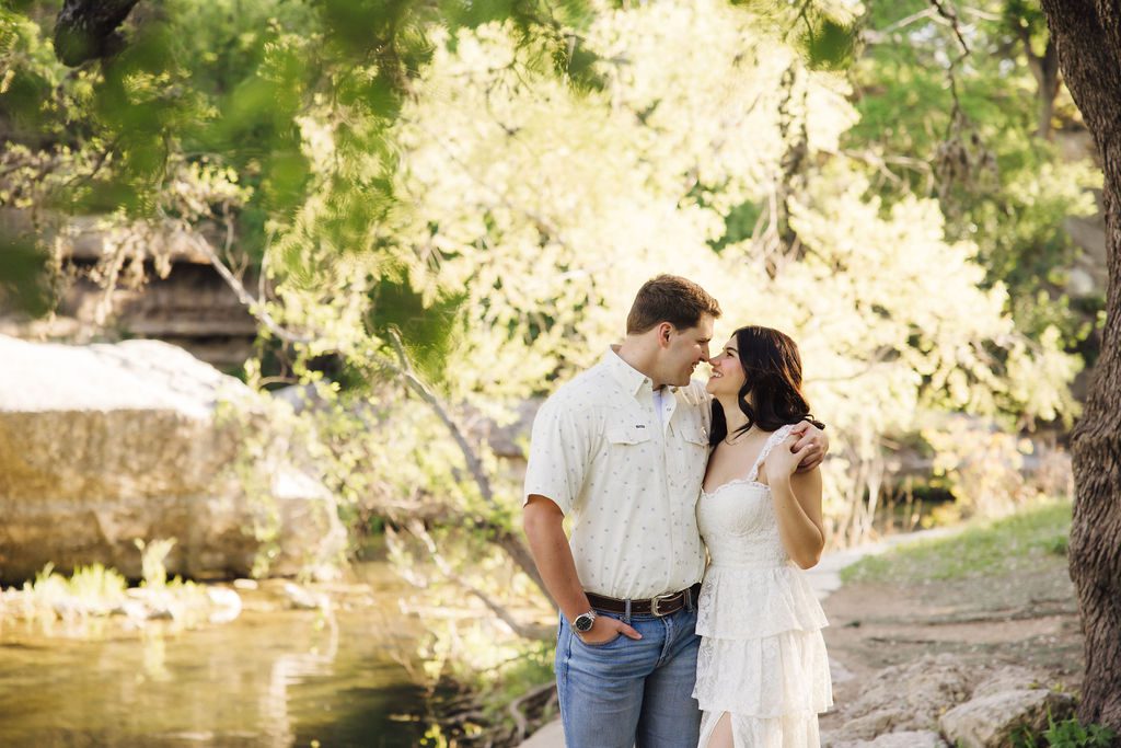 couple posing for engagement photos at Bull Creek District Park in Austin TX