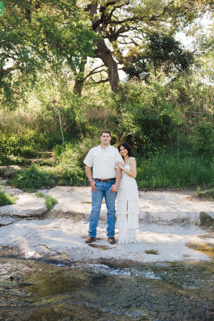 couple posing for engagement photos at Bull Creek District Park in Austin TX