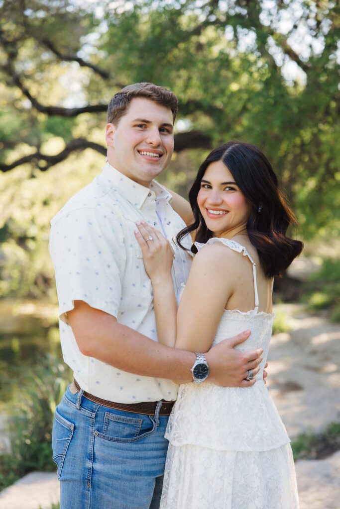 couple posing for engagement photos at Bull Creek District Park in Austin TX