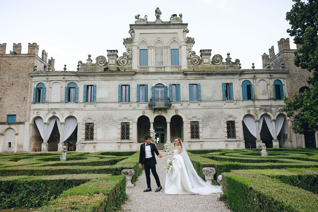 wedding couple in the garden of their Italian destination wedding venue