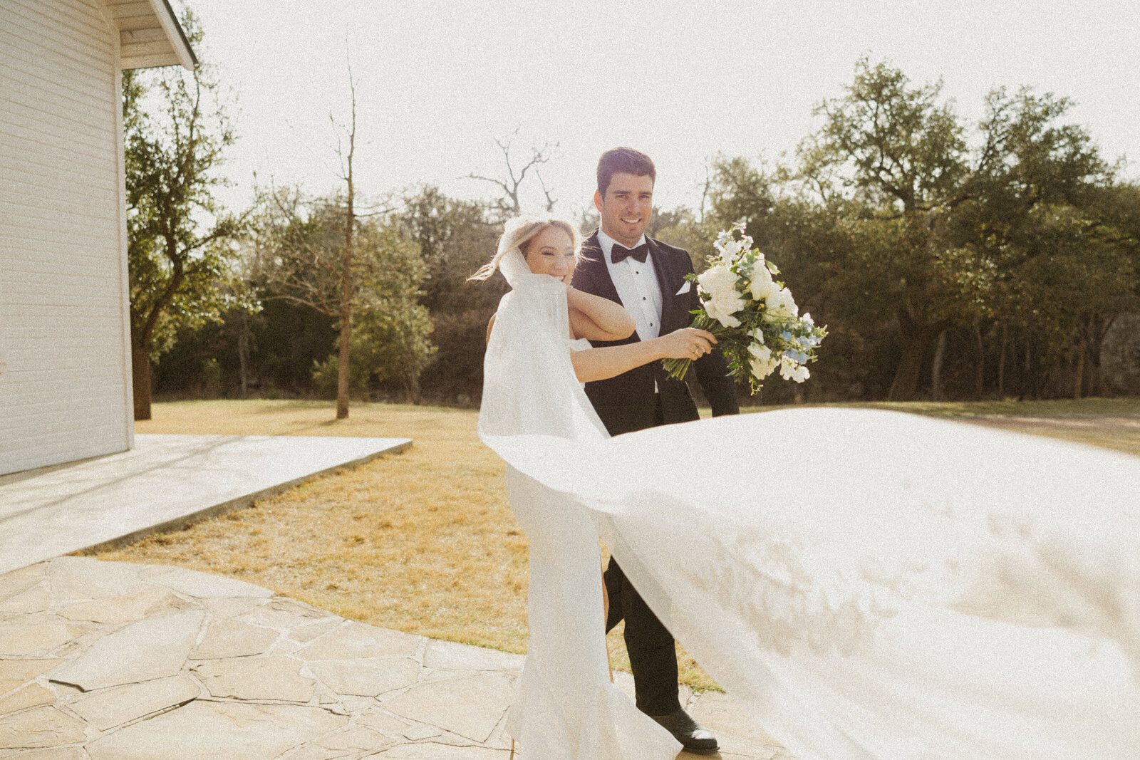 grainy film photo of a bride and groom outside at their La Bonne Vie Ranch wedding